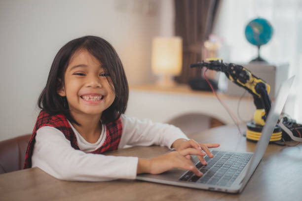 istock STEM education concept. Asian students learn at home by coding robot arms in STEM, mathematics engineering science technology computer code in robotics for kids' concepts. 2108734123