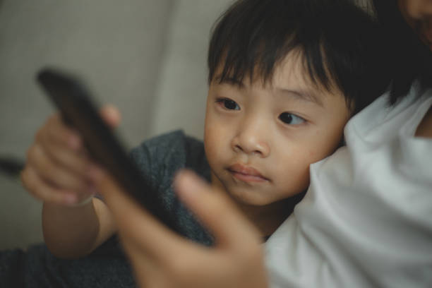 istock Child-addicted phone concepts. Asian boy playing smartphone, kid use telephone, watching smartphone. 2108734652