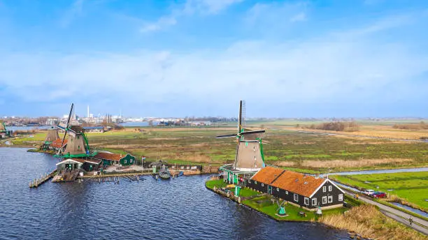 Photo of Aerial view of from traditional windmills at Zaanse Schans in the Netherlands, Rotating mills aerial shooting, Rural scene with windmills in Netherlands, Ancient wooden windmills of Zaanse Schans, The most popular tourist destination in the Netherlands