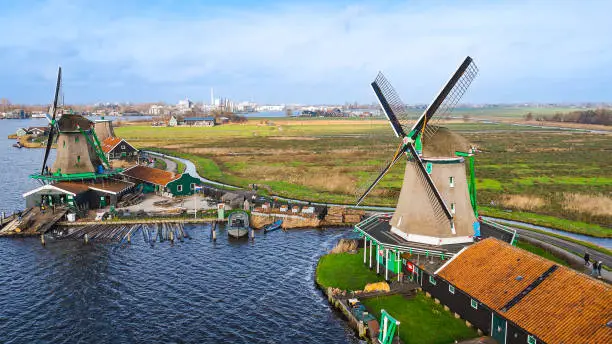 Photo of Aerial view of from traditional windmills at Zaanse Schans in the Netherlands, Rotating mills aerial shooting, Rural scene with windmills in Netherlands, Ancient wooden windmills of Zaanse Schans, The most popular tourist destination in the Netherlands