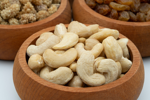 Healthy dried nuts and fruits in wooden bowl. Raw Cashew Nuts.