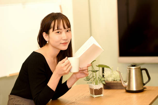 Asian young beautiful woman reading indoors