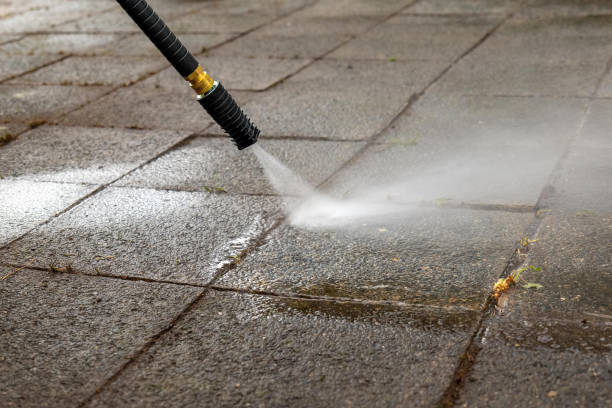 istock pressure washer is spraying water on a dirty sidewalk 2108817606