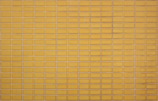 Yellow ceramic wall background. Mosaic tiles texture wall