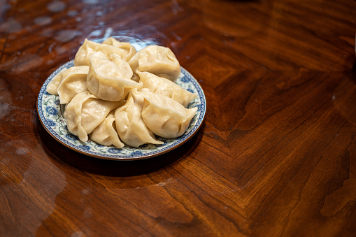 The boiled dumplings in the plate on the table