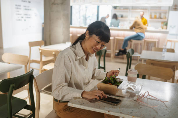 istock Woman having a lunch break in the office cafeteria 2108869115