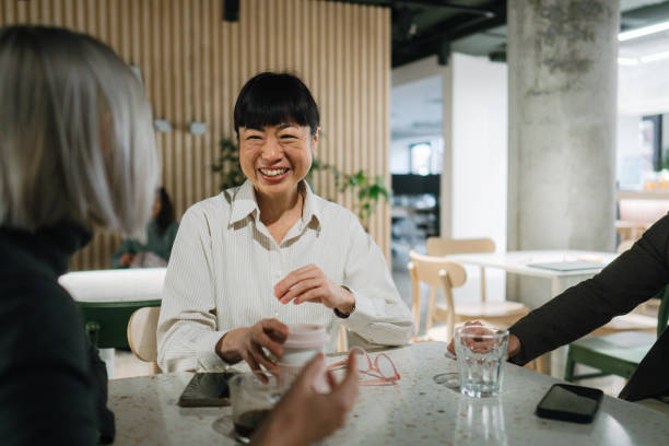 istock Colleagues taking a break in the office cafeteria 2108869622