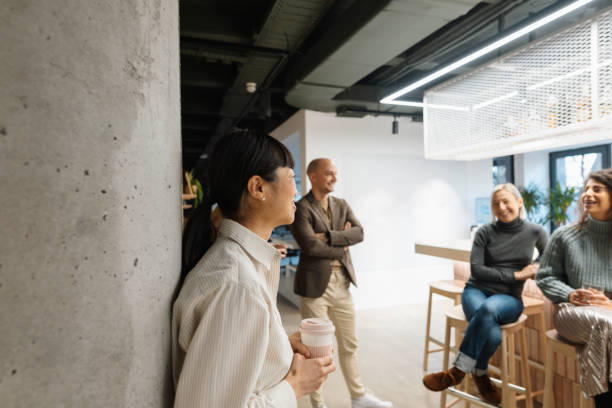 istock Colleagues taking a break in the office cafeteria 2108871152