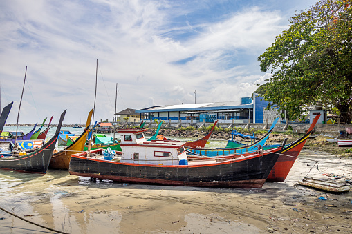 Sabang, Pulau Weh, Indonesia - January 11th 2024: Traditional fishing vessels in a natural harbor  in the city of Sabang which in the main city on the island Weh north of Sumatra