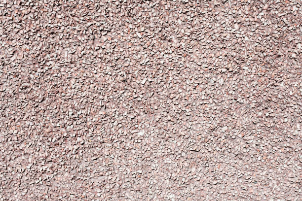 Little stones background. Gray noise backdrop. Stone facade texture.