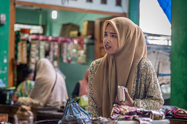Sabang, Pulau Weh, Indonesia - January 14th 2024: Female customer at a market stall in the marked hall in the city of Sabang which in the main city on the island Weh north of Sumatra