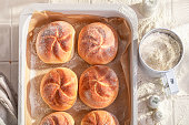 Hot and golden kaiser rolls baked fresh in the bakery.