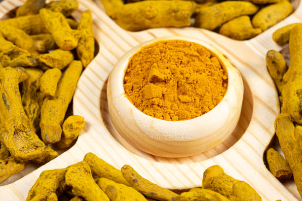 istock Turmeric powder and dried turmeric root top view. 2108995689