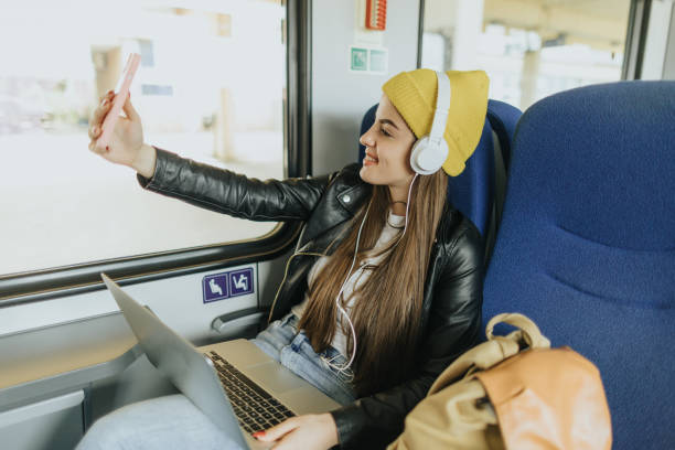 istock Young female commuter taking selfie in the train 2109002972