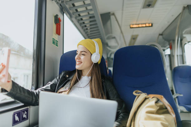 istock Young female commuter taking selfie in the train 2109004025