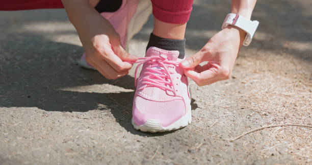 istock asian woman tie tight shoelace 2109049112