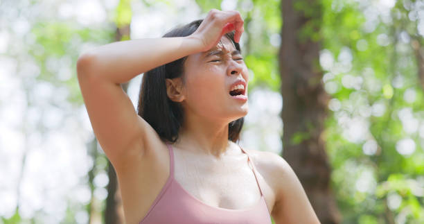 istock woman wipes sweat after exercise 2109053947