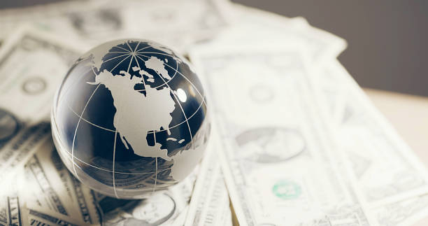 istock Glass globe and money 2109062393