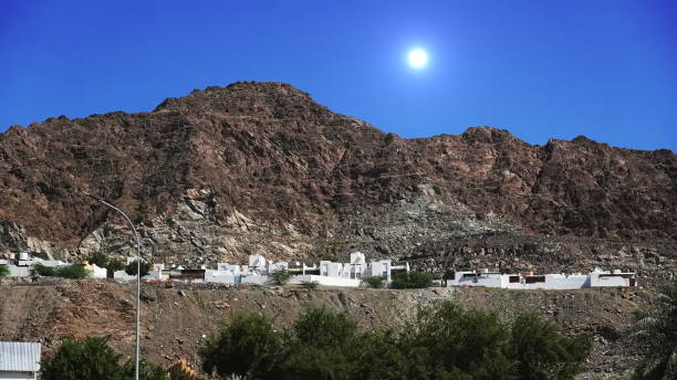 istock Rugged Desert Mountains Towering Over White Village Houses 2109068146