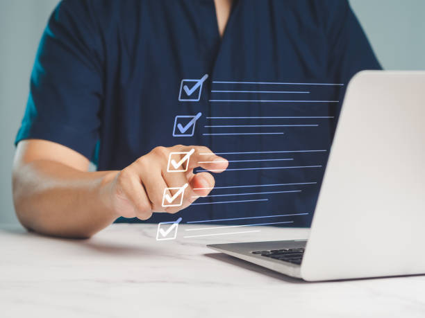istock Businessman pointed to the checklist on an online document list while sitting at a desk. 2109082327