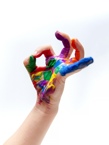 Child with colour paint on his hands isolated on white background