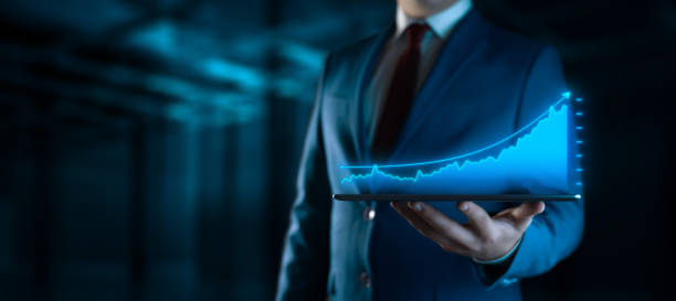 istock growth chart: businessman holds tablet with virtual screen 2109133298