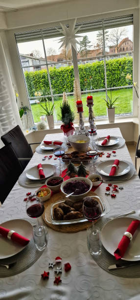 istock Christmas dinner table set with plates, utensils, and candles 2109139060