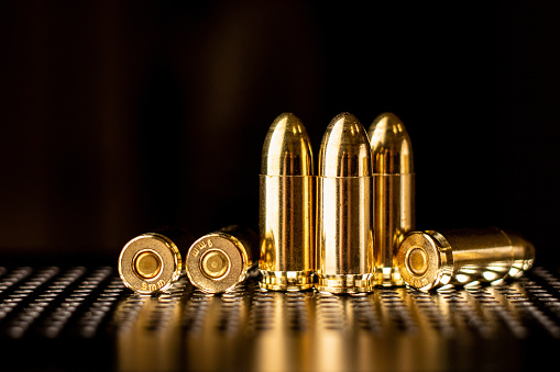 Pistol cartridges 9 mm. Ammunition for pistols and PCC carbines on a dark background.