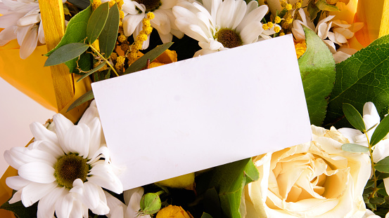 Business card on flowers. Free space for copying. The concept of relationships, self-development and harmony.