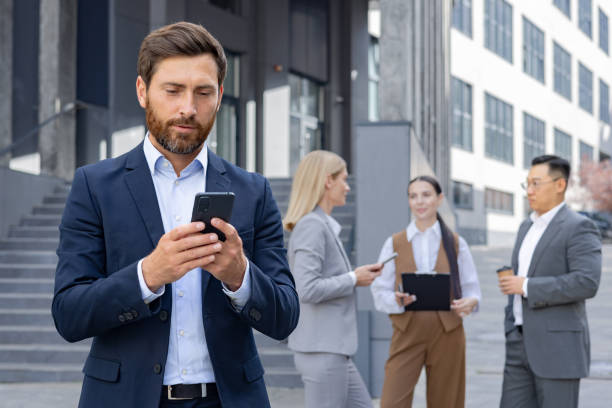 istock Business professionals using smartphones on corporate break 2109180974