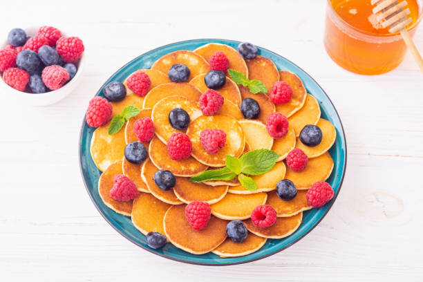 istock Mini pancakes with berries . Delicious breakfast . 2109194650