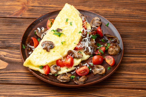 istock Omelette stuffed with mushrooms , tomatoes and parsley 2109194668