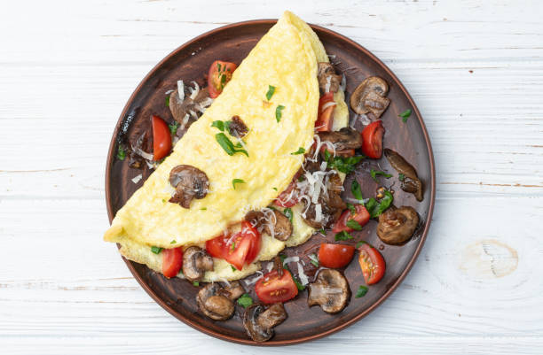 istock Omelette stuffed with mushrooms , tomatoes and parsley 2109194685