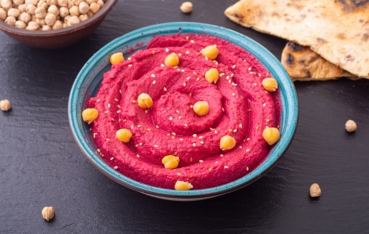 Declicious food from chickpea - beetroot hummus . Israel and arabic kitchen