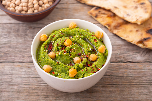 Declicious food from chickpea - green hummus . Israel and arabic kitchen