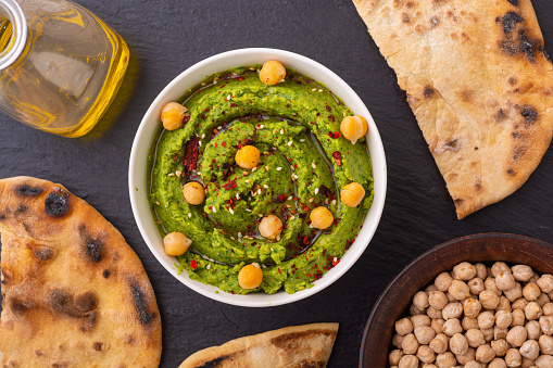 Declicious food from chickpea - green hummus . Israel and arabic kitchen