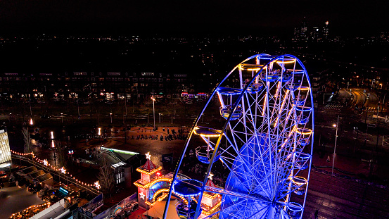 Illuminated Ferris Wheel at Night, A dark night sky and a brightly illuminated funfair wheel, Amusement Park Night View, Illuminated Ferris Wheel, Illuminated Ferris Wheel in Amsterdam at Night