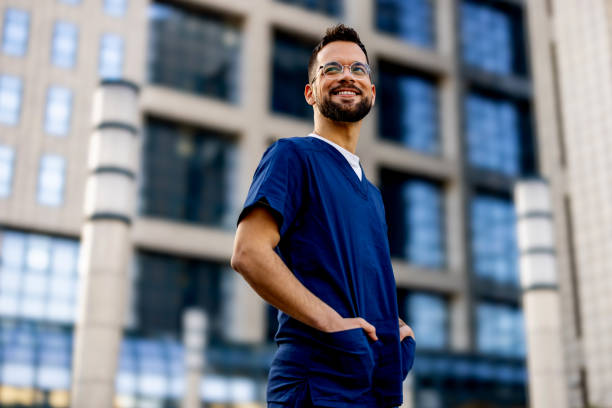 Confident male nurse looking away with smile on his face.
