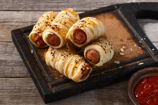 istock Homemade Sausage in dough rolls on plate 2109274669