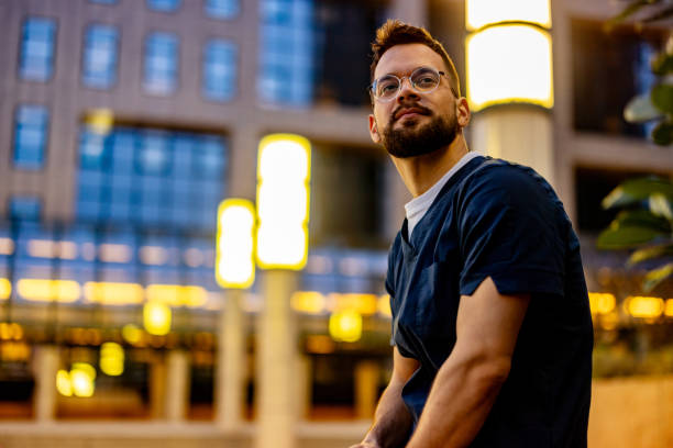 istock Male nurse waiting outdoors. 2109284748