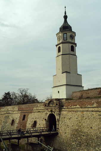 Belgrade, Serbia - View of the historic clock tower in Kalemegdan Park against a cloudy sky.