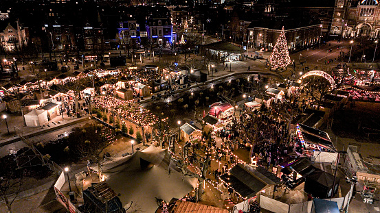 Aerial view of Christmas market in Amsterdam, people shopping at Christmas market, Christmas market with Christmas decorations and Christmas tree, Christmas Time in Europe, aerial view of Dutch Christmas market