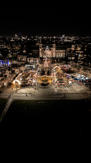 Aerial view of Christmas market in Amsterdam, people shopping at Christmas market, Christmas market with Christmas decorations and Christmas tree, Christmas Time in Europe, aerial view of Dutch Christmas market