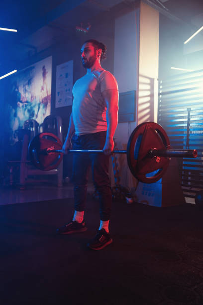 istock Intense Deadlift Focus in Hazy Blue-Red Gym 2109300759