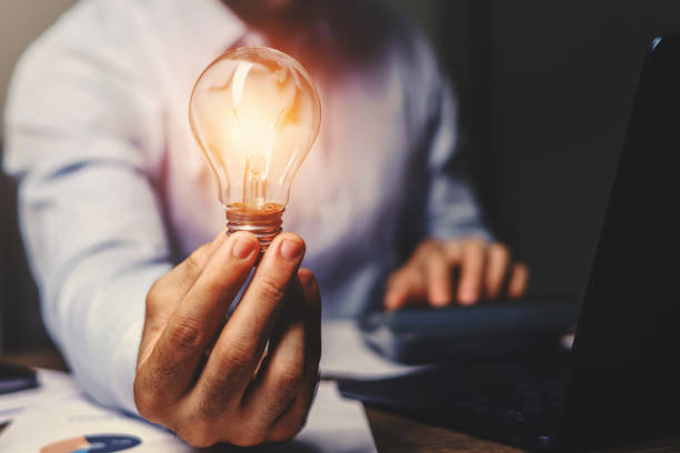 istock person holding a light bulb in their hand 2109300815