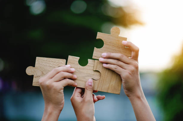 istock Jigsaw puzzle pieces of cooperation and teamwork Aim for great success in work. 2109308703