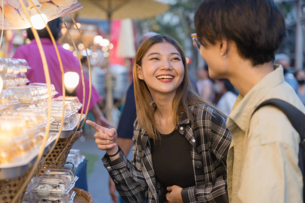 istock Laughing Couple Shopping at Evening Market. 2109325762