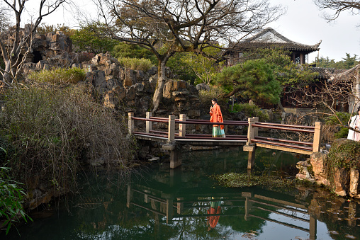 the Humble Administrator's(Zhuozheng)Garden in Suzhou province, China,  It is the best characteristic garden art in China. People are walking on the bridge