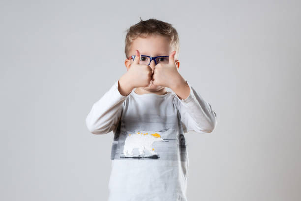 istock A young boy, wearing glasses, enthusiastically gives a thumbs up gesture 2109336737