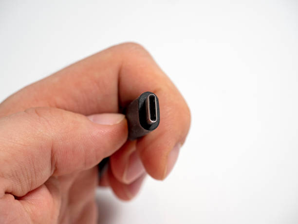 istock The usb type C cable is collapsible with a magnetic attachment in your hand on a white background. 2109340466